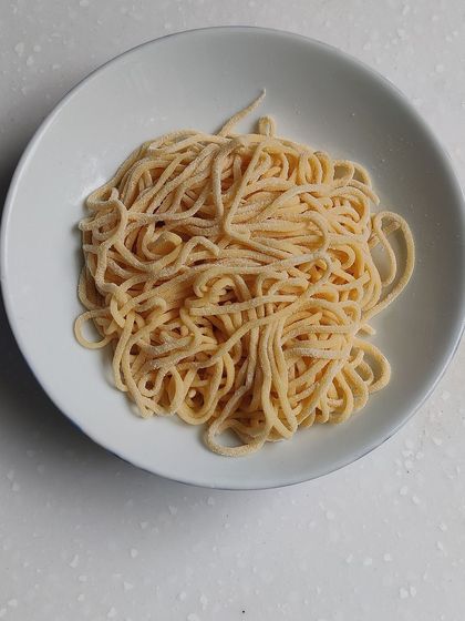 Freshly extruded spaghetti, another pasta shape we explore in our comprehensive Italian cooking module.