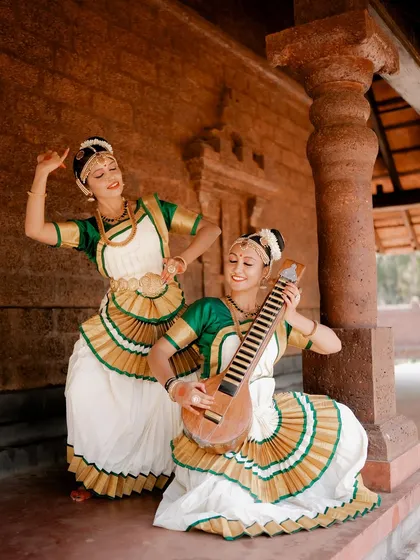 A portrait of two dancers, one playing an instrument while the other poses. This image tells a story of performance and artistic collaboration.