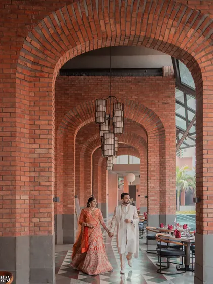 We love using dramatic architecture to frame your story. Here, we used the repeating brick arches of the Avadh Utopia resort to create a sense of grandeur and a beautiful leading line, capturing the couple in a candid, walking pose that feels both epic and natural.
