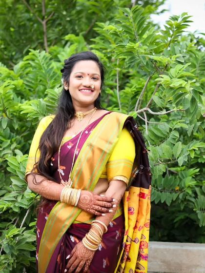 A full-length portrait from a traditional portfolio shoot. This image shows the complete look, from the elegant saree drape to the model's confident pose.