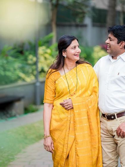 A candid shot of a couple sharing a happy moment while walking through a park. We focus on capturing the natural chemistry between partners.