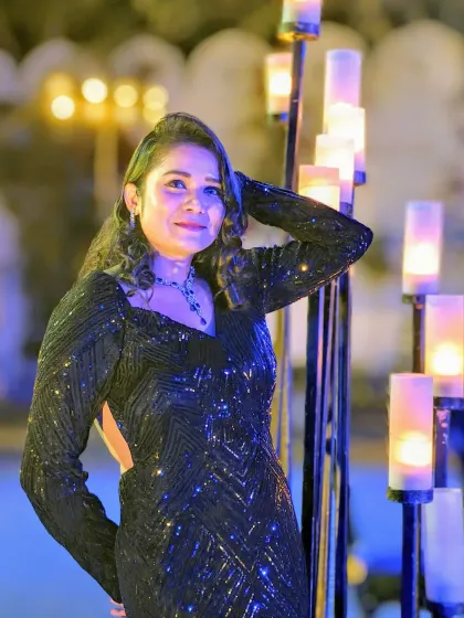 A close-up shot from a Sangeet night, ready to engage with the crowd. The warm candle lights add to the intimate and celebratory feel of the evening.