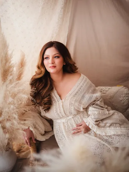 We explore various angles and compositions to build a diverse gallery for your clients. This image demonstrates a classic seated pose within a beautifully styled boho set.