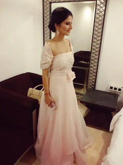 This light pink off-shoulder gown is one of my signature pieces, perfect for a roka, engagement, or cocktail party. The design features a flowing organza skirt and a bodice covered in delicate hand embroidery with pearls and sequins for a touch of glamour.