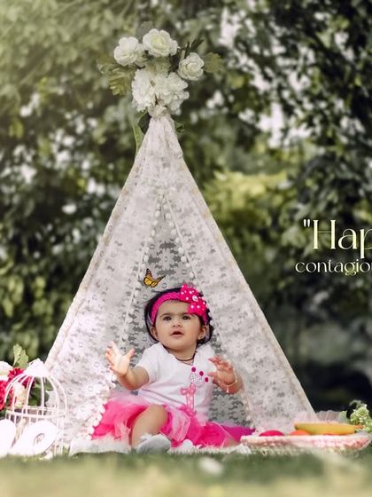 Happiness is contagious, and this kid's a carrier. A fun and vibrant outdoor first birthday session with a pink theme and our lace teepee.
