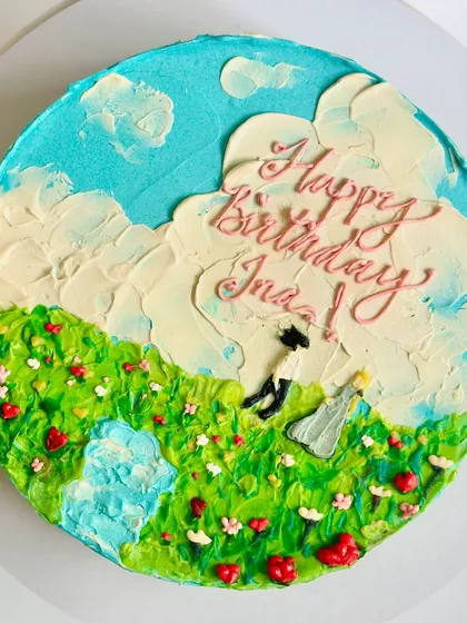 A top-down view of the countryside painting cake, showing the couple dancing in a field of flowers. Every element is thoughtfully placed to create a beautiful scene.