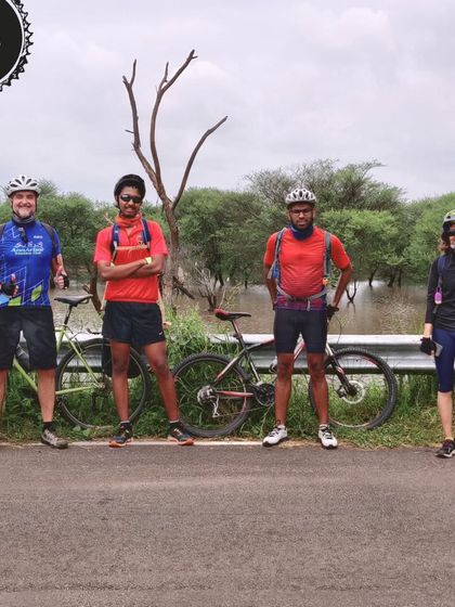 A group of proud riders posing by a flooded section of the trail. Every ride is an adventure, and we love the camaraderie that comes with it.