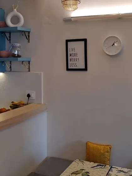 A cozy corner in our Lotus Boulevard project. The small details like the wall clock, art print, and open shelves make the space feel personal and lived-in.