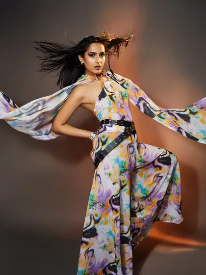 A high-fashion look with a flowing, colorful outfit and minimal, clean makeup that lets the clothing shine.