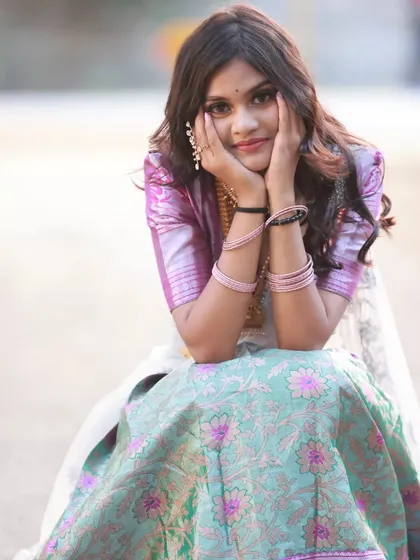 A cute and playful pose, with the model resting her face in her hands. This adds a touch of sweetness to the series.