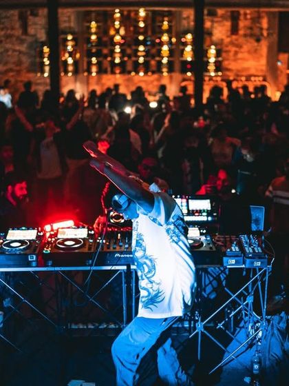 A wide shot showing the full setup and the crowd's reaction. This captures the entire scene and the shared experience of the night.