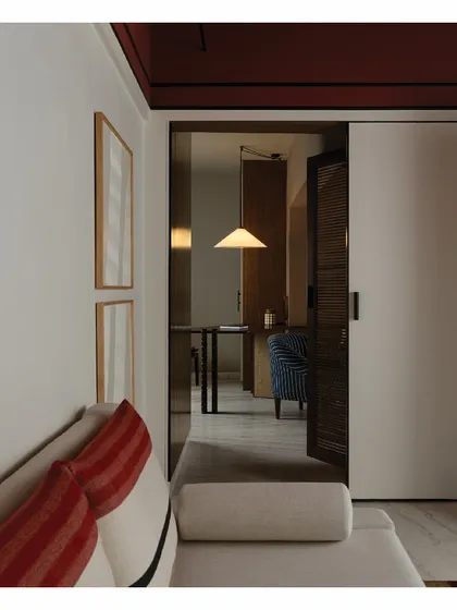 A view from one room into another, showing how we use custom furniture and lighting to create a cohesive feel. Every piece, from the wardrobes to the tables and even some lights, is custom-made to fit the story of the house.