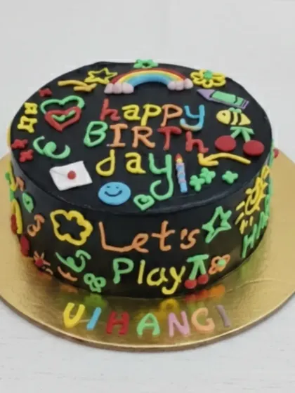 A fun and colorful doodle cake with a chocolate flavor. The black frosting provides a perfect canvas for vibrant, hand-piped doodles, making it a playful choice for any birthday.