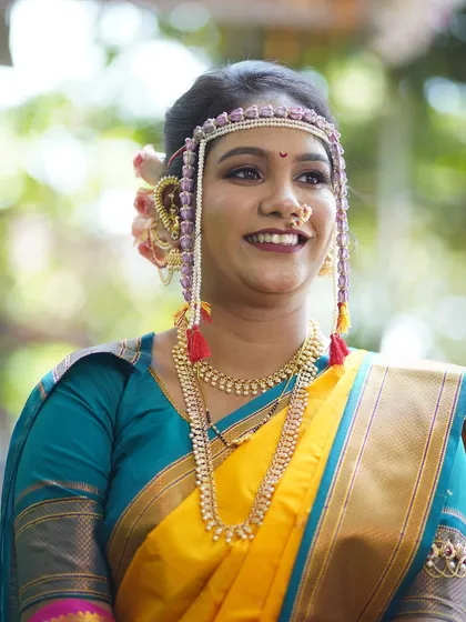A candid, happy portrait. The bride's natural smile is the centerpiece, complemented by a makeup look that is fresh and luminous.