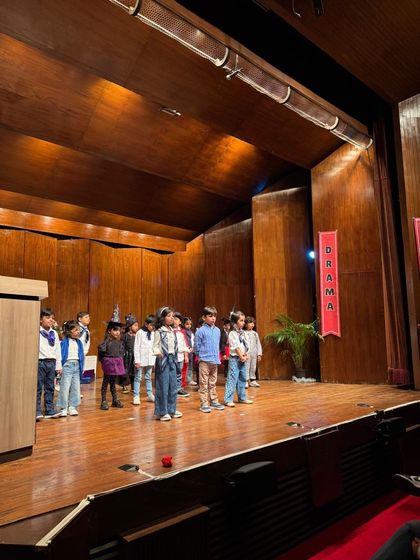 The entire cast lines up on stage, ready for their final bow after a fantastic group performance.