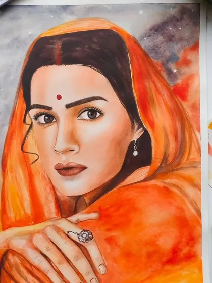 A watercolor portrait of Kriti Sanon as Sita from the movie Adipurush. The warm, glowing background contrasts with her serene expression.
