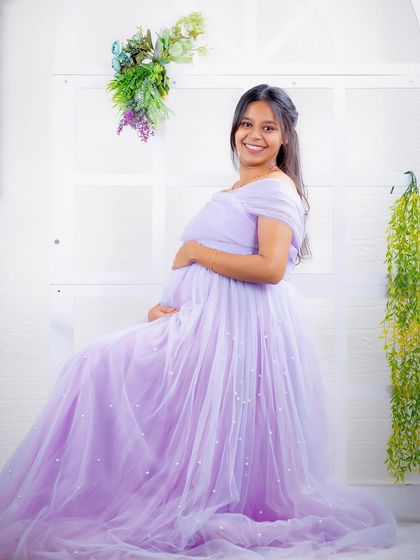 A seated portrait in our lavender Breezy gown. The dress drapes beautifully, creating a soft and elegant look in our studio.