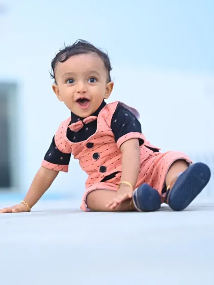 A happy one-year-old birthday boy, Derick. Our photography services focus on capturing the pure joy and personality of your child on their special day.