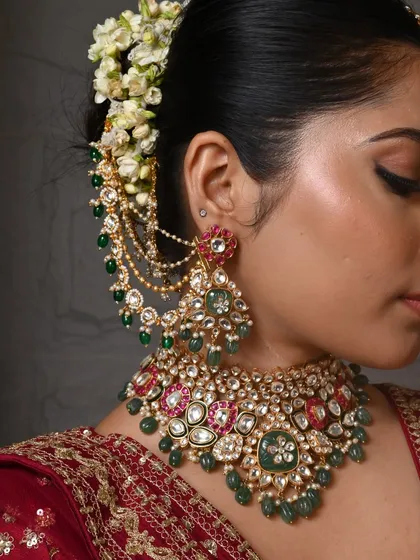 It's all in the details. This close-up shows an intricate bridal choker set with Kundan, vibrant ruby and emerald colored stones, and elegant earchains. I can customize the bead colors to match your bridal lehenga perfectly.