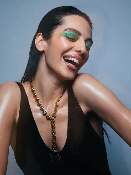 A joyful expression paired with a bold eye and glowing skin. I love capturing these candid moments on set.