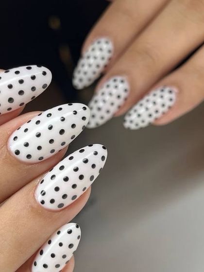 Another angle of the chic black and white polka dot nails, showing the perfect almond shape and flawless application of the design.