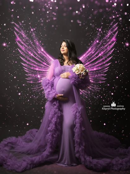 Explore our packages to get your maternity session done with stylish fabric drapes and wings, like this beautiful purple angel portrait.