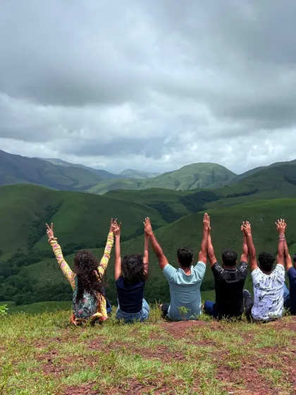 This is what pure happiness looks like. A moment of joy with fellow trekkers on the rolling grasslands of Kudremukha, with a massive view of the mountains behind us.