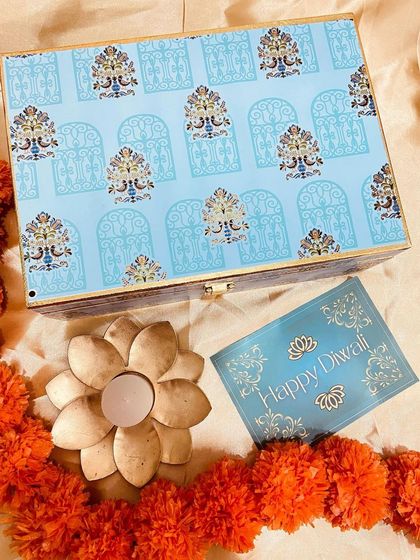 The lid of our elegant blue printed trunk box, featuring a beautiful pattern. This box can be repurposed long after the festival is over.
