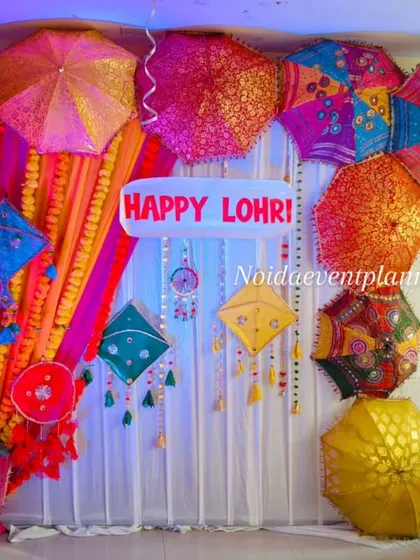 We use creative lighting to enhance our festive decor, making the colors of the Lohri backdrop pop even more in the evening.