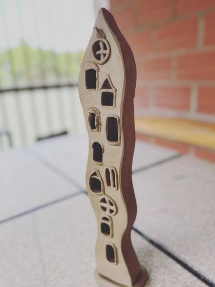 A still from the video, showing the full height of the whimsical window-covered lamp sculpture.