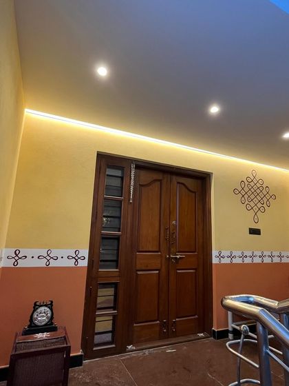 The finished look of the minimalistic rangoli patterns at the house entrance. The clean lines and traditional motifs create a warm and welcoming atmosphere, beautifully illuminated by the modern lighting.