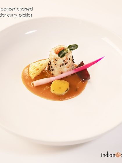 This is our achari paneer, served with a charred coriander curry and pickles. The dish balances the tang of pickling spices with the smokiness of the curry for a complex flavour profile.