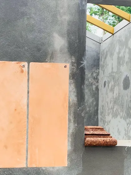 During the construction of a new Coorg home, I experiment with lime plaster swatches against the raw structure. This process is crucial for ensuring the final color and texture are in perfect harmony with the local laterite stone and the surrounding environment.