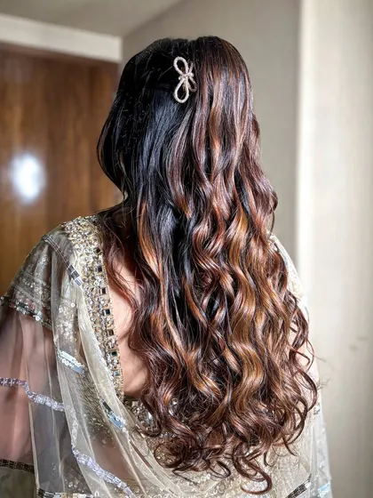 The hairstyle for this look was soft, open curls with a simple, elegant hair clip, keeping the look modern and chic.