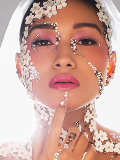 Makeup is an art form, and sometimes we love to push creative boundaries. This editorial look uses delicate flowers and shimmering crystals to create a truly magical and ethereal bridal concept.