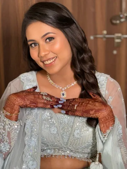 A playful shot showing the bride's happiness. The makeup is fresh and light, allowing her natural beauty to shine through.