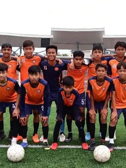 My team and coaches together on the field. We are a unified force, dedicated to achieving excellence.
