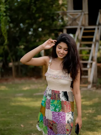 A duplicate of image 131, this candid and happy portrait of actress Rachana Inder on a bamboo ladder is full of joy and natural beauty.