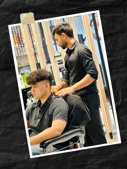 The same client getting a relaxing shoulder massage after his haircut, a part of our complete grooming experience.