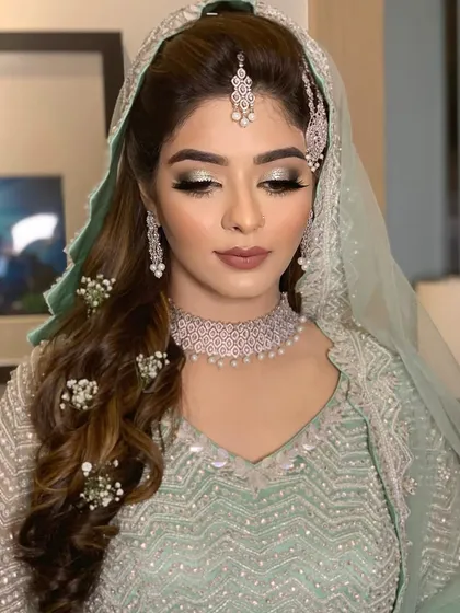 A stunning Walima look for Farheen. The makeup features a silver-toned smokey eye and a matte nude lip to complement her ethereal mint green outfit.