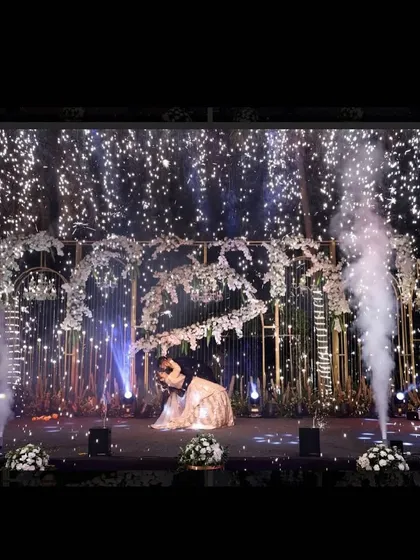 A solo performance on a grand stage, complete with cold pyros and a sky of twinkling lights. I design stages that make the performers, especially the bride and groom, feel like stars.