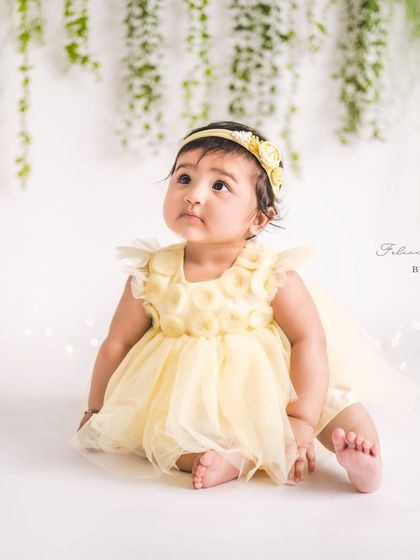 A little ray of sunshine in a yellow dress. Sitter sessions are all about capturing your baby's unique spirit, and this little one's joy is absolutely radiant.