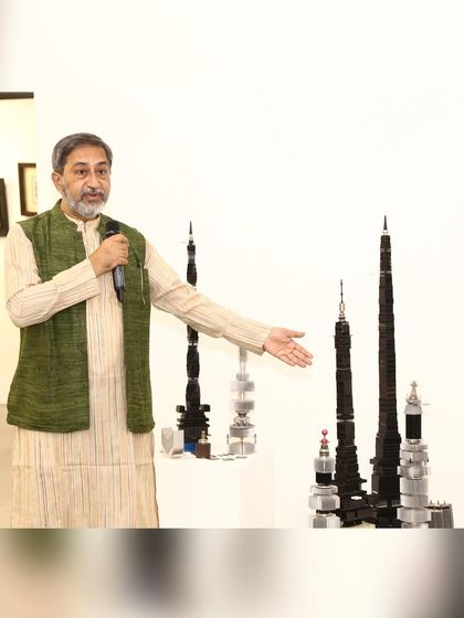 Here I am at my solo exhibition, presenting my 'Future City' sculpture series. These pieces are made from discarded heat sinks and other electronic parts, reimagined as futuristic skyscrapers to comment on modern urbanization and sustainability.