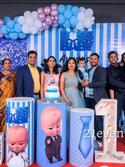 A lovely family portrait in front of the Boss Baby birthday decorations.