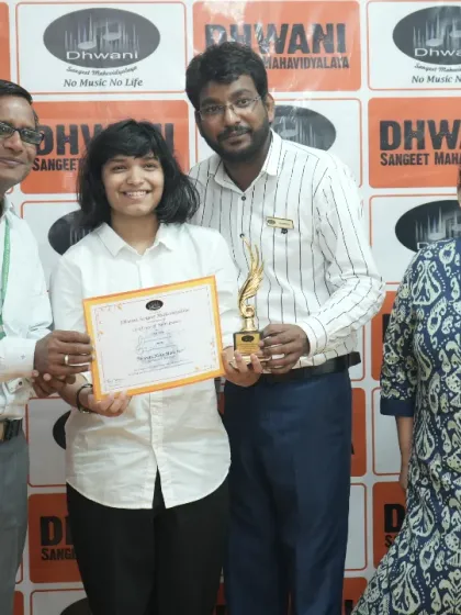 A student, her mother, and teachers celebrate her win at the prize ceremony.