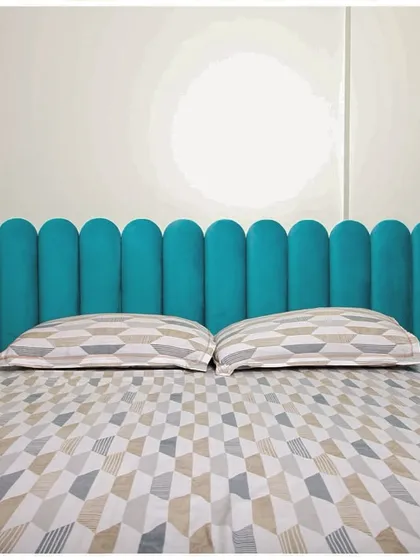 A frontal view of the beautiful teal headboard, demonstrating how a single, bold design choice can define the character of a room.