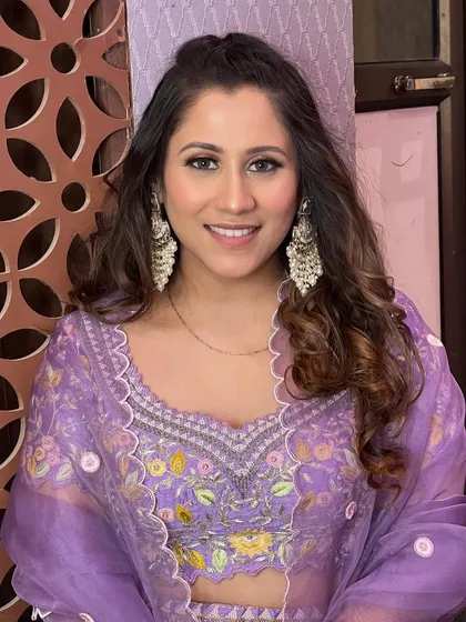 A happy and confident client, looking beautiful in her glamorous makeup.