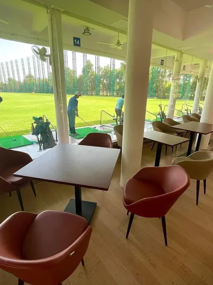 The view from inside The Players Cafe, where you can watch golfers on the range while you relax and dine.