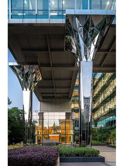 The faceted stainless steel-clad columns at the entrance of the Jindal Stainless Steel headquarters. This radical intervention was our design solution to introduce the company's key material right at the building's exterior.