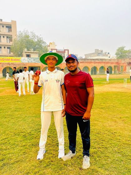 Manish Sindhu holding the match ball after taking 5 wickets.
